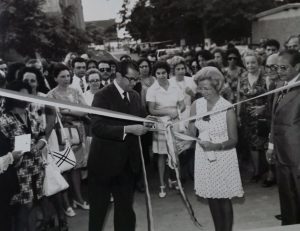 Descrição da imagem: Solenidade de inauguração do CENESP. No centro da imagem, à direita, Sarah Couto Cesar, diretora-geral do CENESP, e à esquerda, Jarbas Passarinho, Ministro da Educação, participam do descerramento da fita de inauguração. No canto direito da foto, em primeiro plano, os diretores do Instituto Nacional de Educação dos Surdos (INES) e do Instituto Benjamin Constant (IBC) observam o ato. Ao fundo, um grupo de pessoas também acompanham a solenidade. Entre elas, autoridades públicas, representantes da sociedade civil e assessores do CENESP, como Dorina de Gouvêa Nowill e Olívia da Silva Pereira.